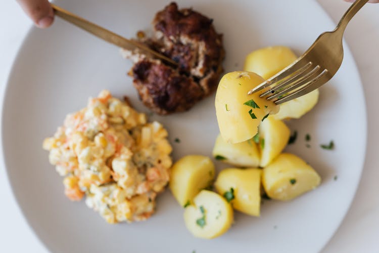 Plate With Boiled Potatoes Russian Salad And Meat Cutlet