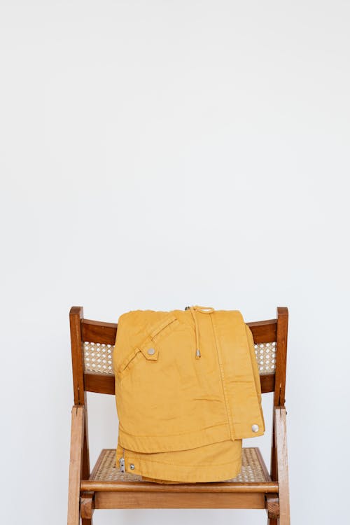 Free Yellow parka on wooden chair Stock Photo
