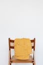 Yellow parka on wooden chair