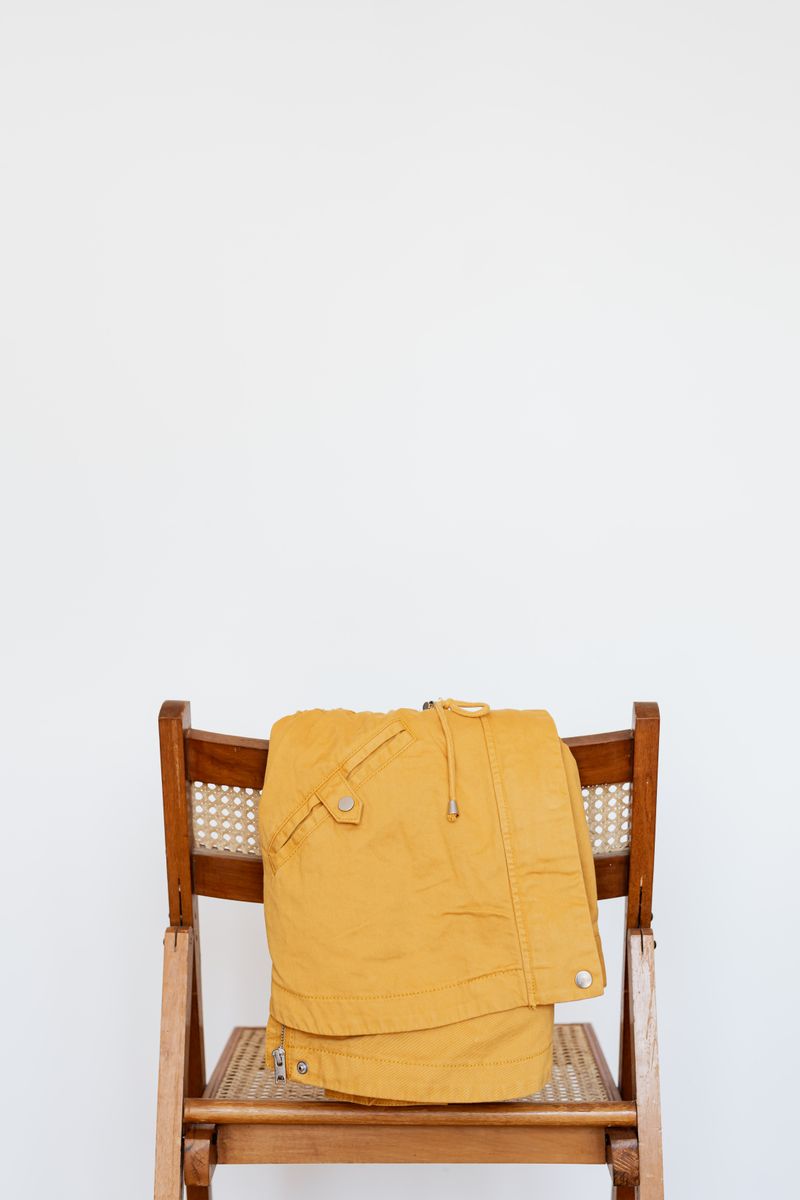 Raw denim with waxy sheen next to well-worn faded denim showing matte texture