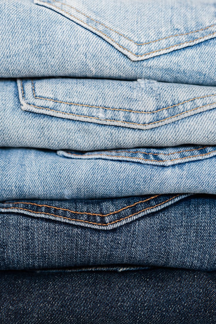 Stack Of Blue Jeans Arranged By Color