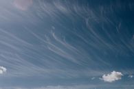 Magnificent blue sky with slowly floating light white clouds on warm summer day