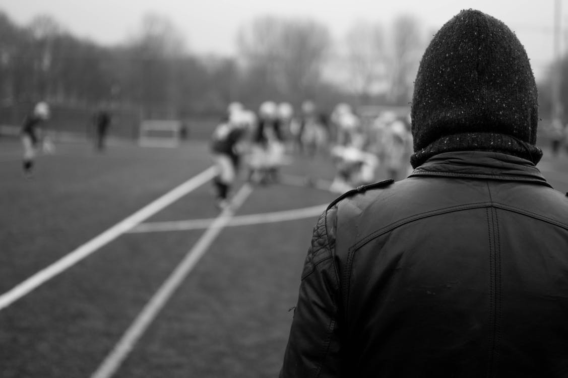 Free Grayscale Photography of Person Wearing Leather Jacket and Knit Cap Stock Photo