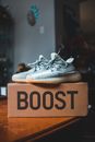 Pair of modern sneakers on box on table