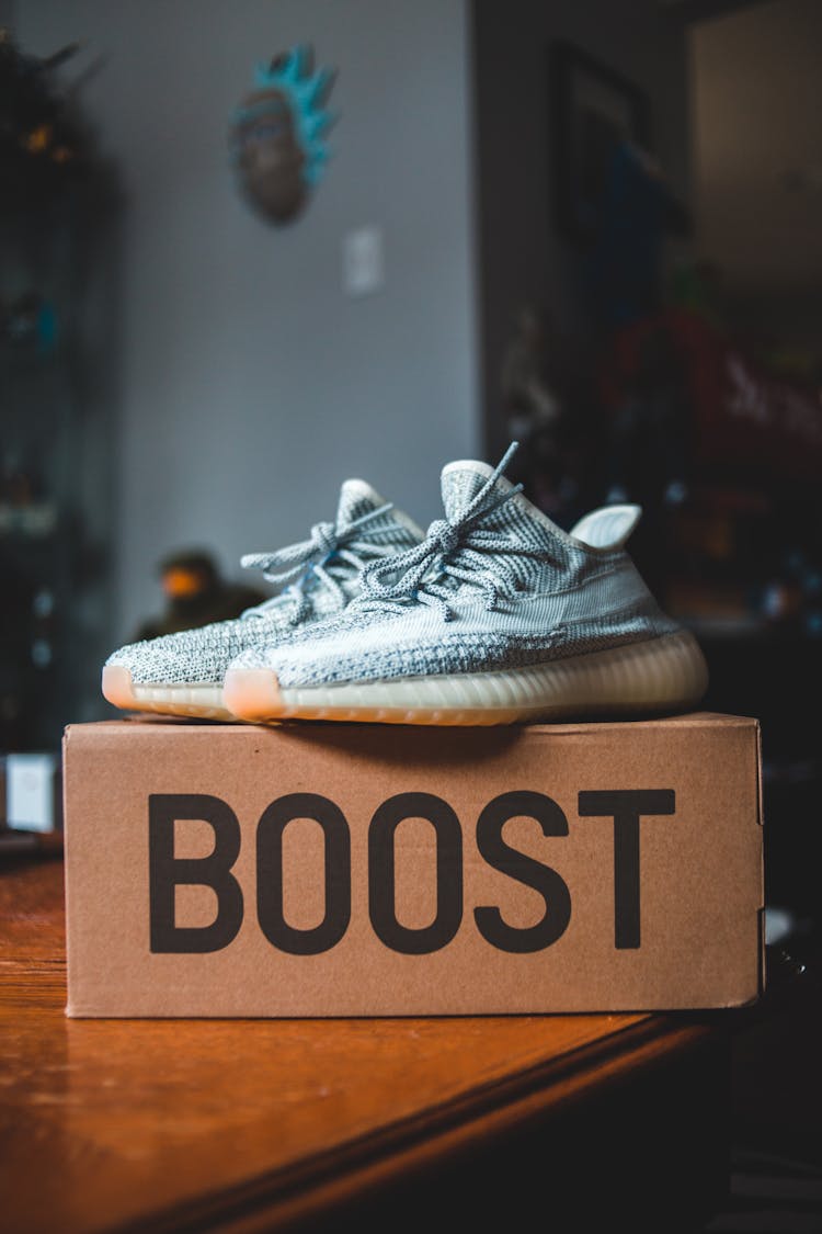 Pair Of Modern Sneakers On Box On Table