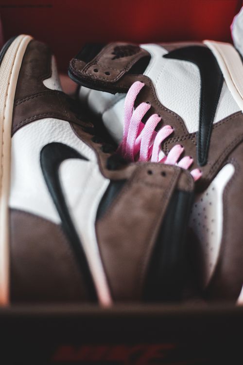 Free From above of contemporary gumshoes with pink laces and soft material in box Stock Photo