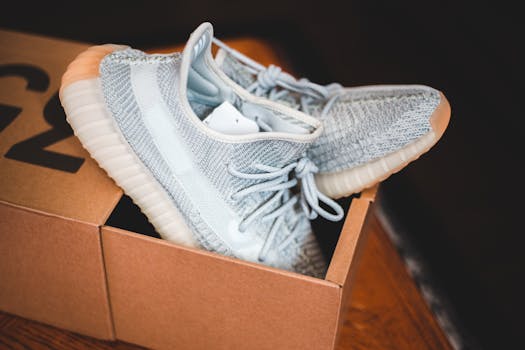 Stylish sneakers in a modern cardboard box setting indoors.