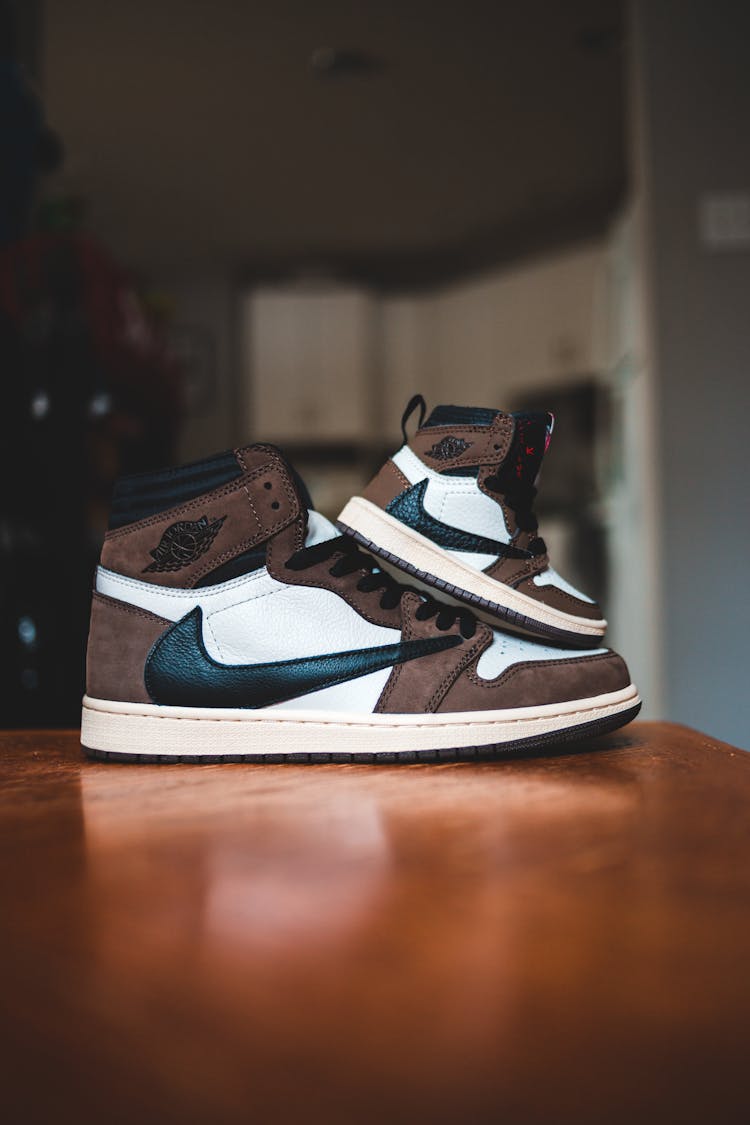 Pair Of Stylish Sneakers On Desk At Home