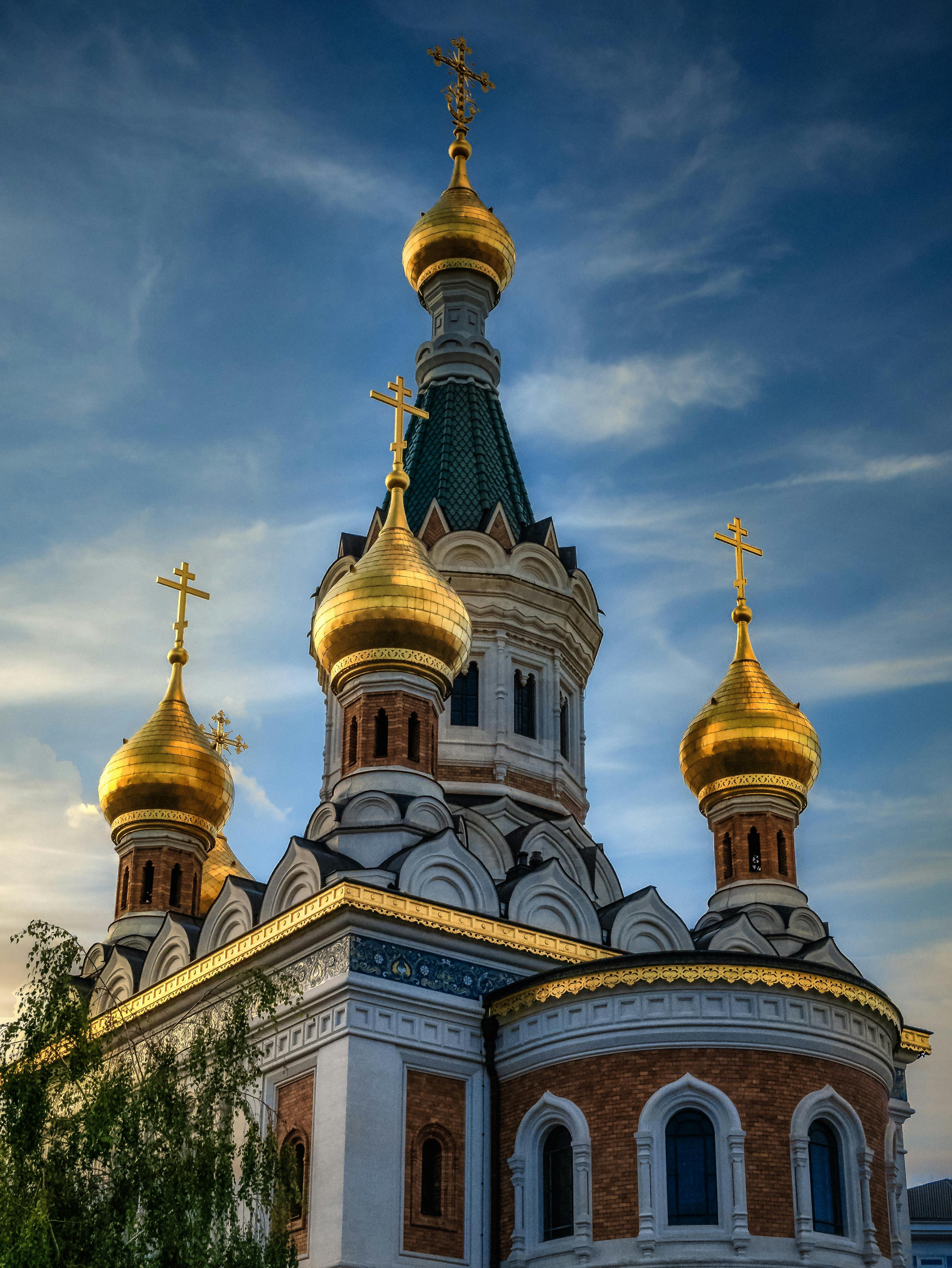 Old stone basilica facade near greenery trees in town · Free Stock Photo