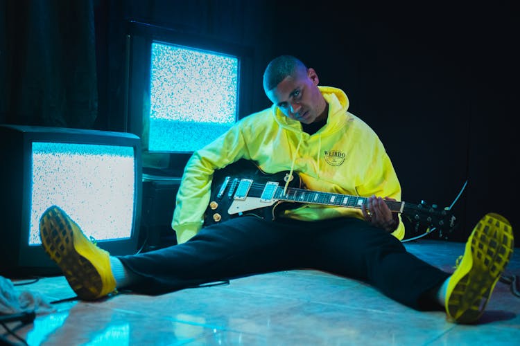 Stylish Black Musician With Electric Guitar On Floor