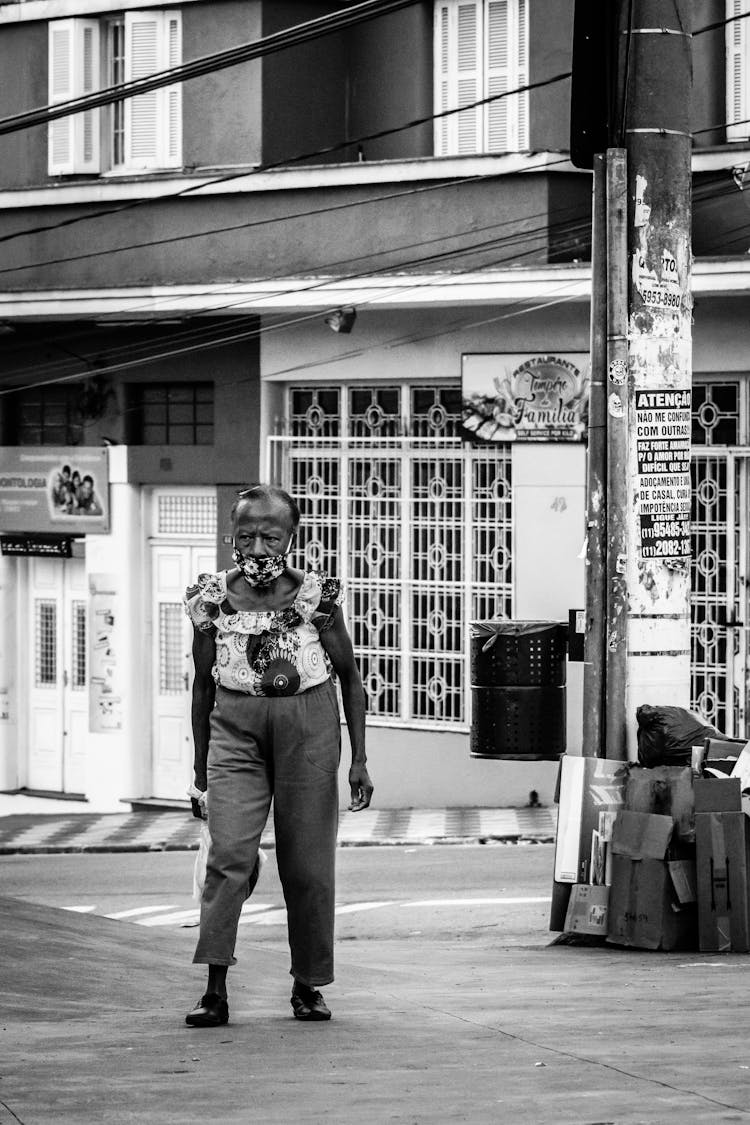 Elderly Woman In Mask Walking On City Street