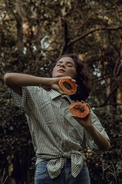 Woman holding Sliced Papaya 