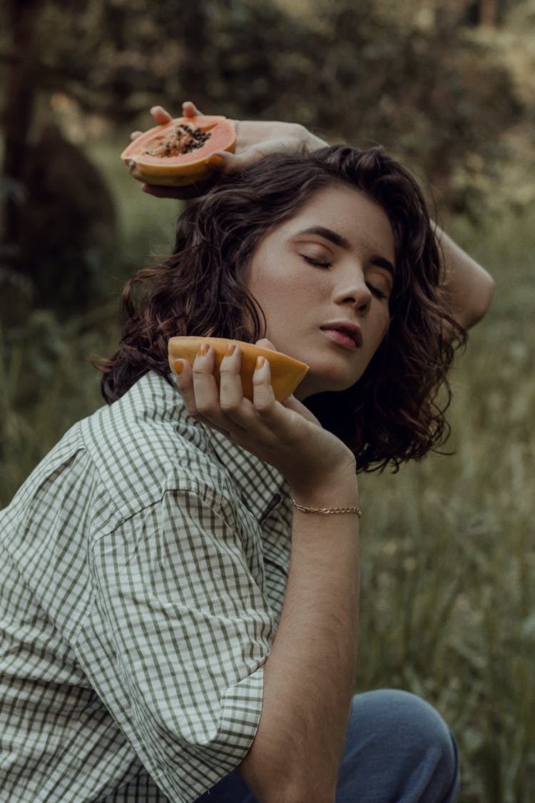 Woman Holding Sliced Papaya 