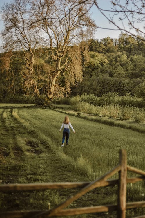 Free Woman walking on Grassland  Stock Photo