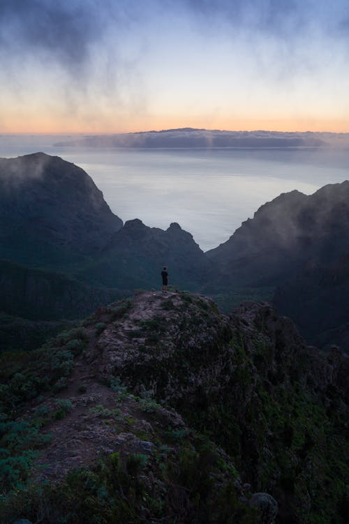 Free Person Standing on Top of Mountain Stock Photo