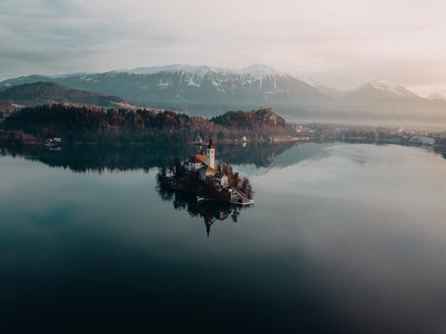 Free A tranquil aerial view of Lake Bled and its island in Slovenia during a misty day. Stock Photo