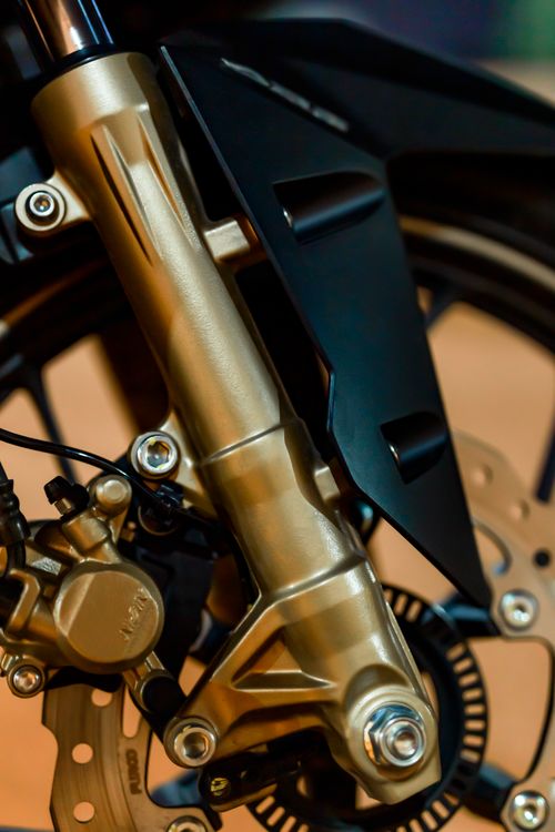 Free Closeup of modern motorbike wheel with brake panel and fork tube fixed with screws Stock Photo