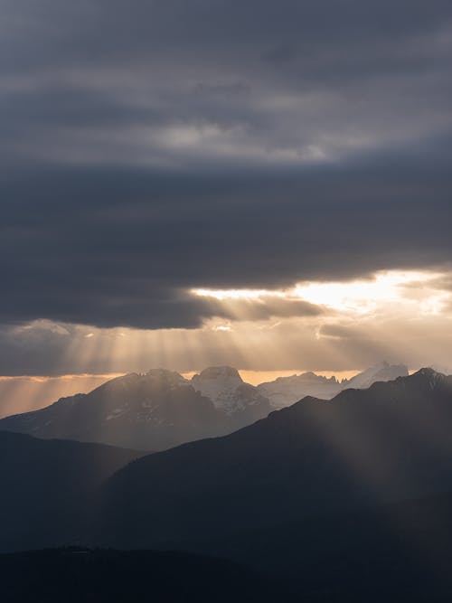 Silhouette of Mountains Under Cloudy Sky