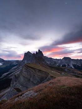 Breathtaking view of the Seceda mountain peak during sunrise in the Dolomites, Italy.