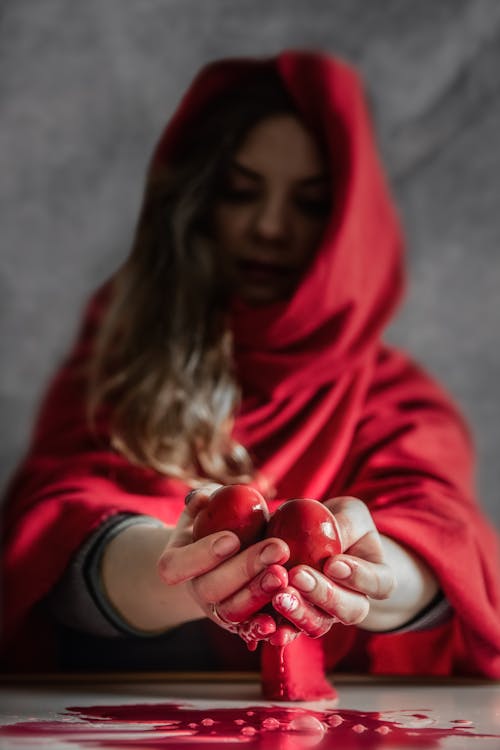Woman in Red Hijab Holding Red Apple Fruit