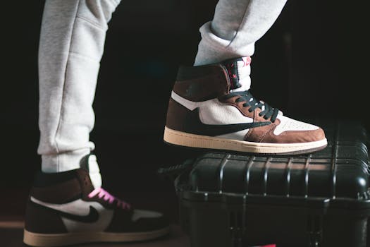 High top brown and white sneakers showcasing modern fashion on a dark background.