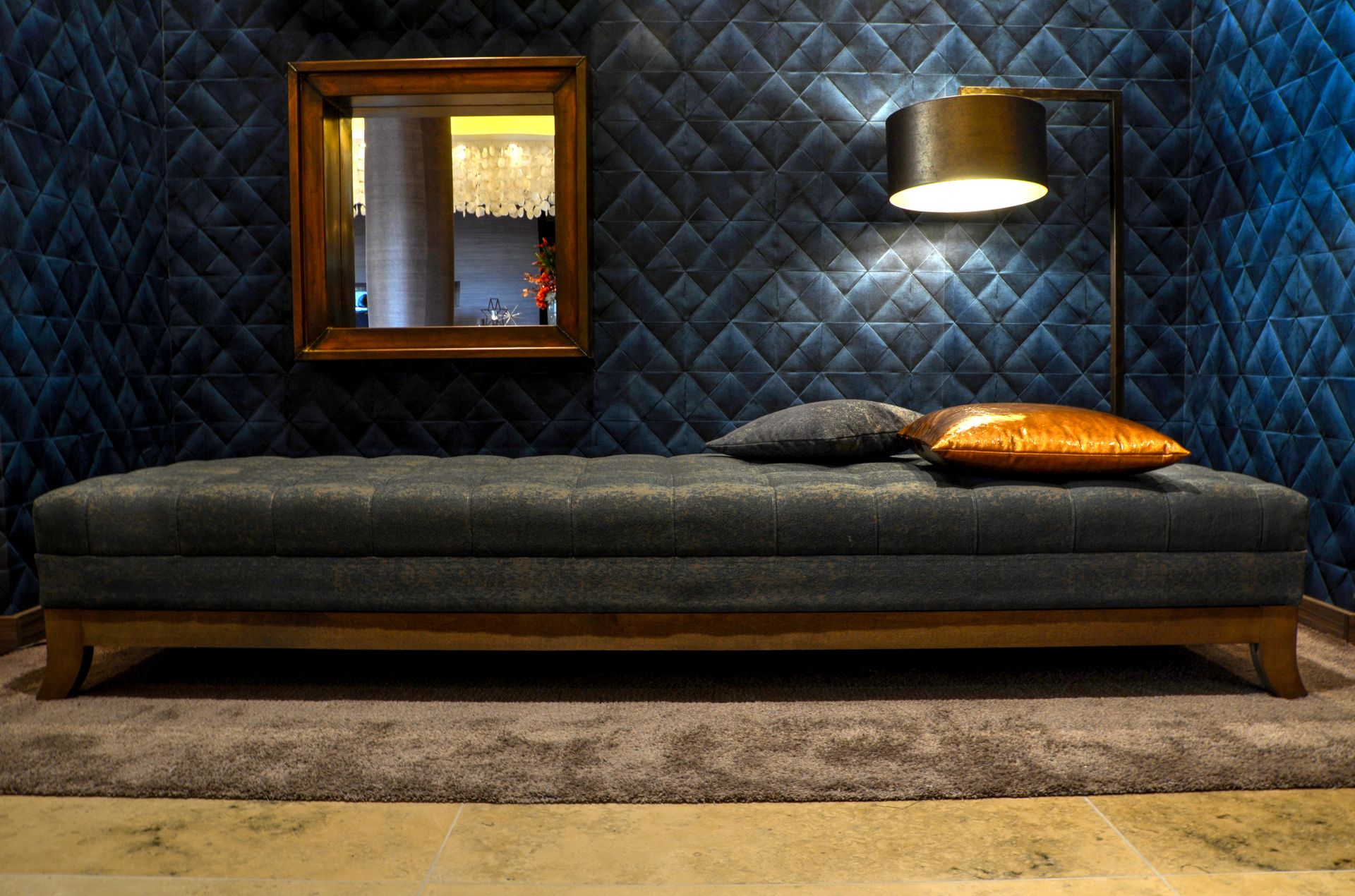 A stylish and modern bedroom featuring a cozy daybed and ambient floor lamp.