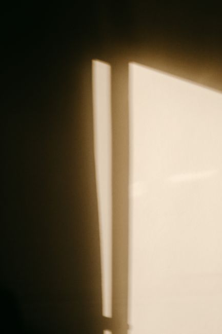 From below of glowing window with white cloudy sky view in house in daylight