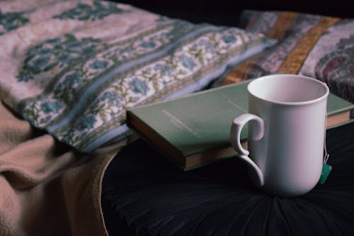 Mug and book placed on table