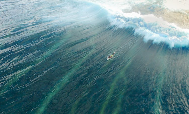 Man On Surfboard Surfing On Wave