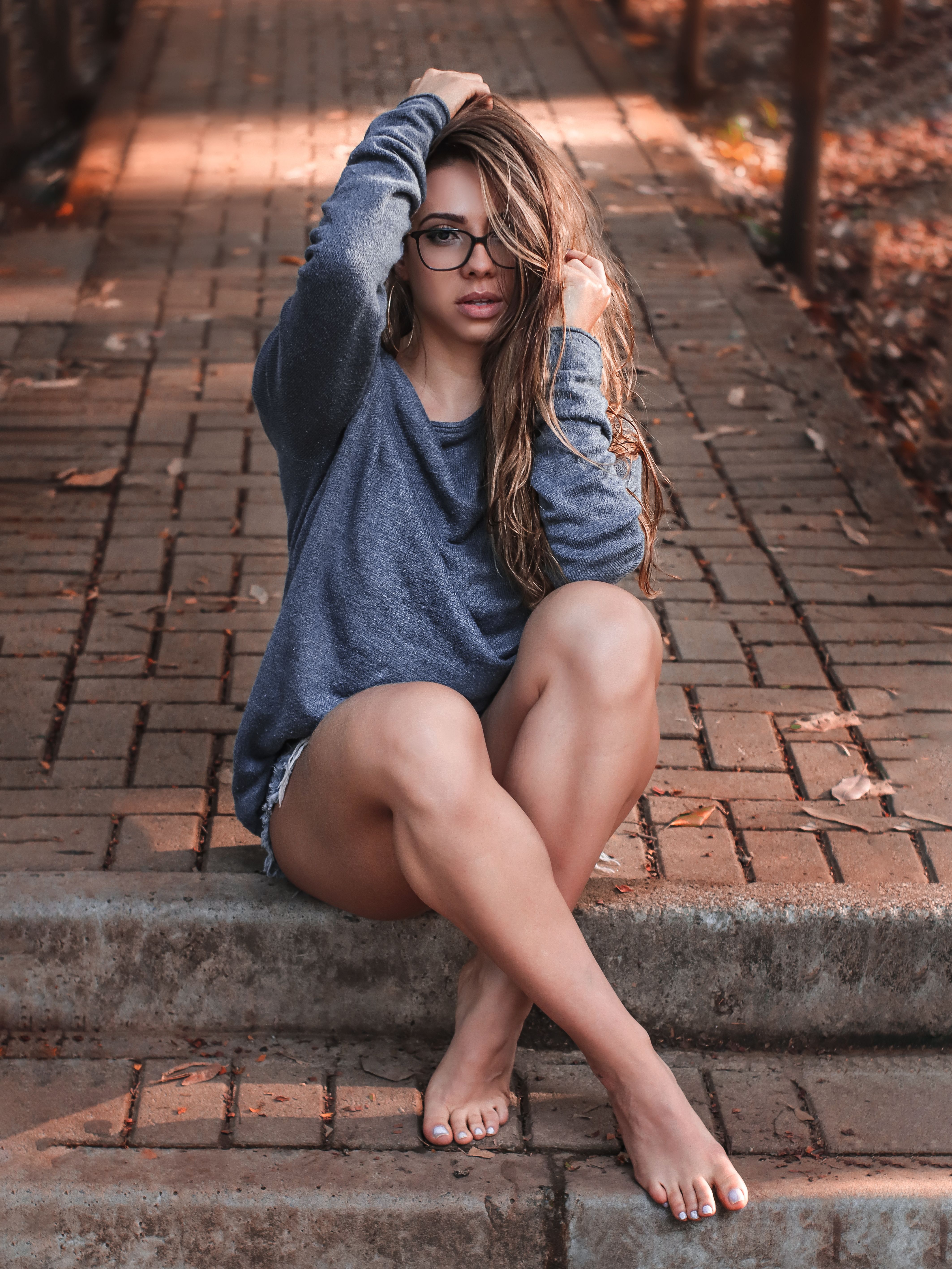 Sensitive woman sitting on paved walkway in park &middot; Free Stock Photo