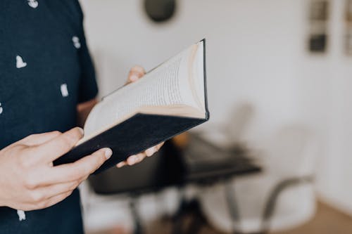 Free Photo of Person Holding Opened Book Stock Photo