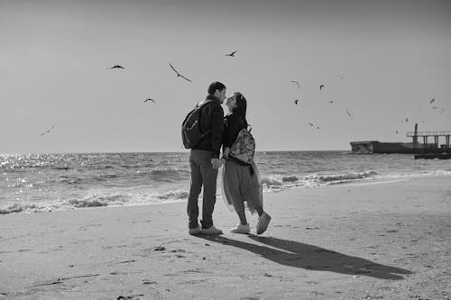 Man and Woman Standing on Seashore