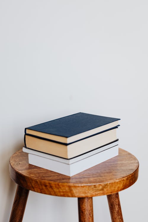 Stack of Books on Wooden Stool