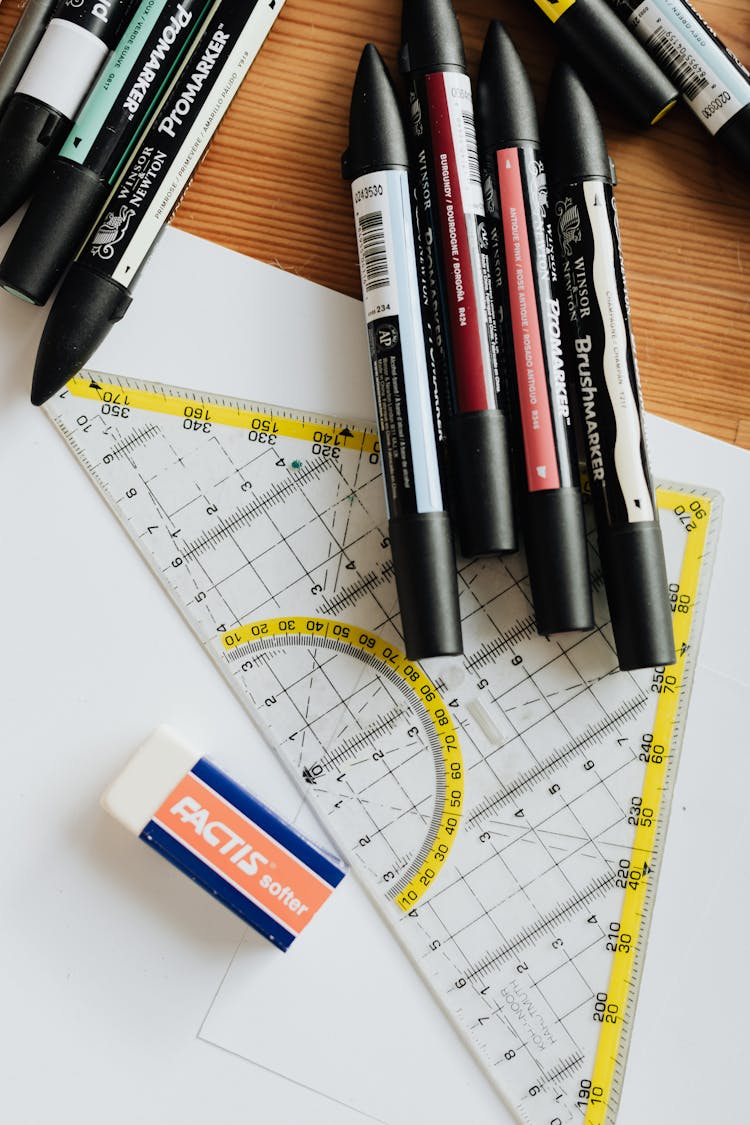 Drawing Triangle With Eraser On Paper Sheets