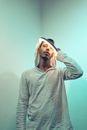 Stylish young ethnic guy with illuminated lamp on head
