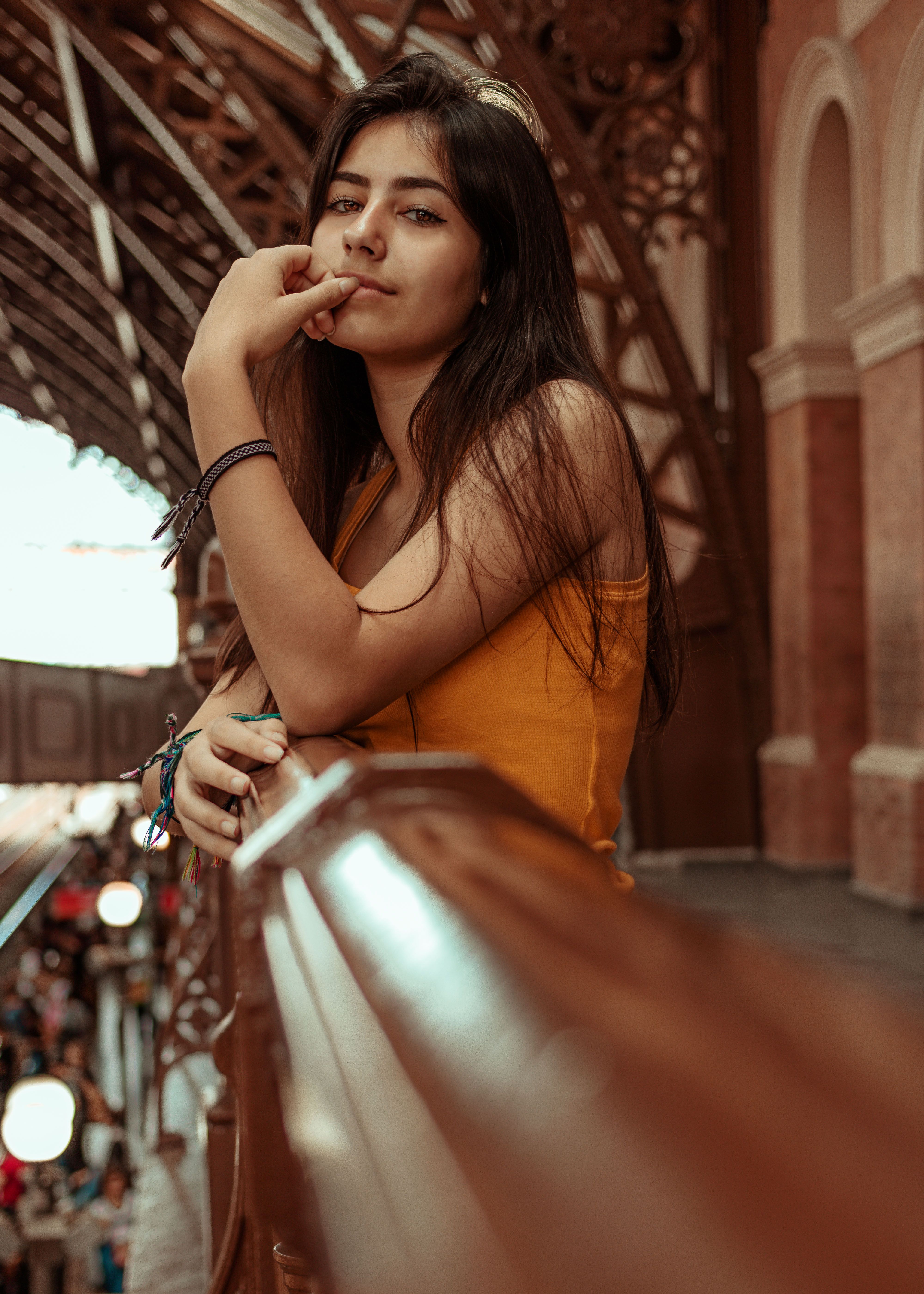 Woman in Orange Sleeveless Dress Leaning on Wooden Railing · Free Stock ...