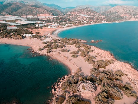 Beautiful aerial view of a serene Mediterranean coastline with clear turquoise waters and sandy beaches.