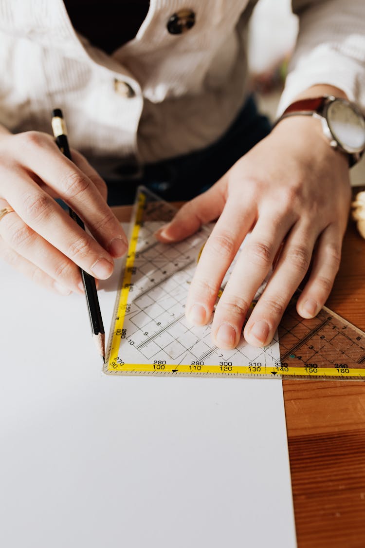 Photo Of Person Using Ruler