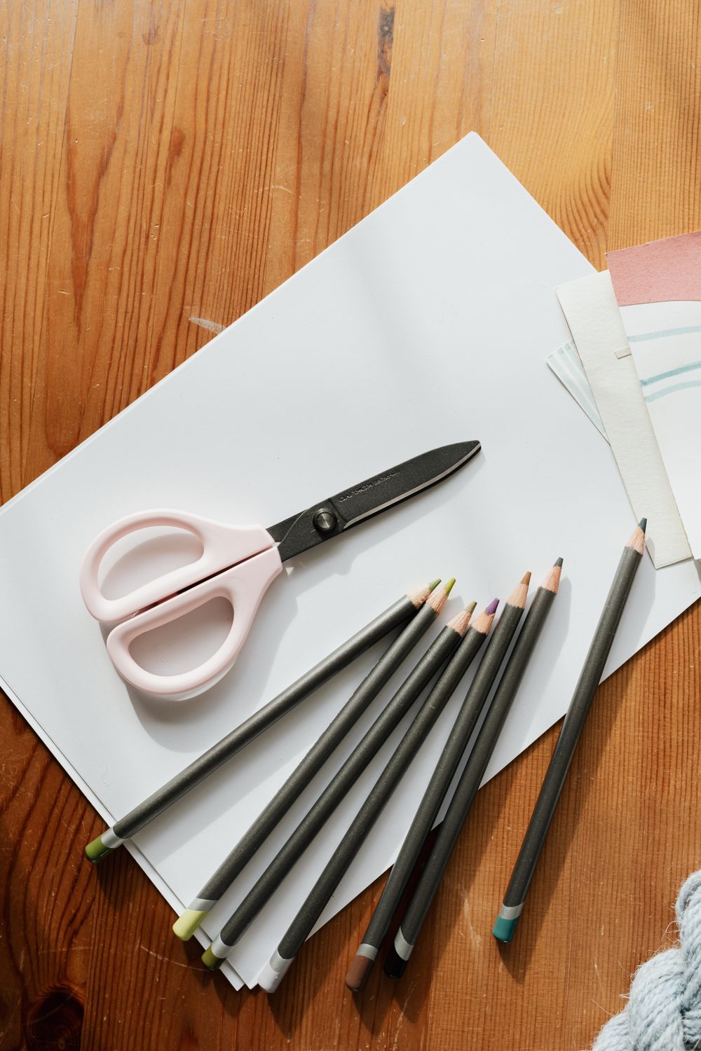 Scissors and Colored Pencils on White Paper · Free Stock Photo