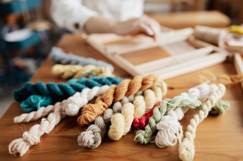 Close-Up Photo of Ropes on Wooden Table