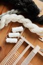 Small hand wooden loom with yarn and thread