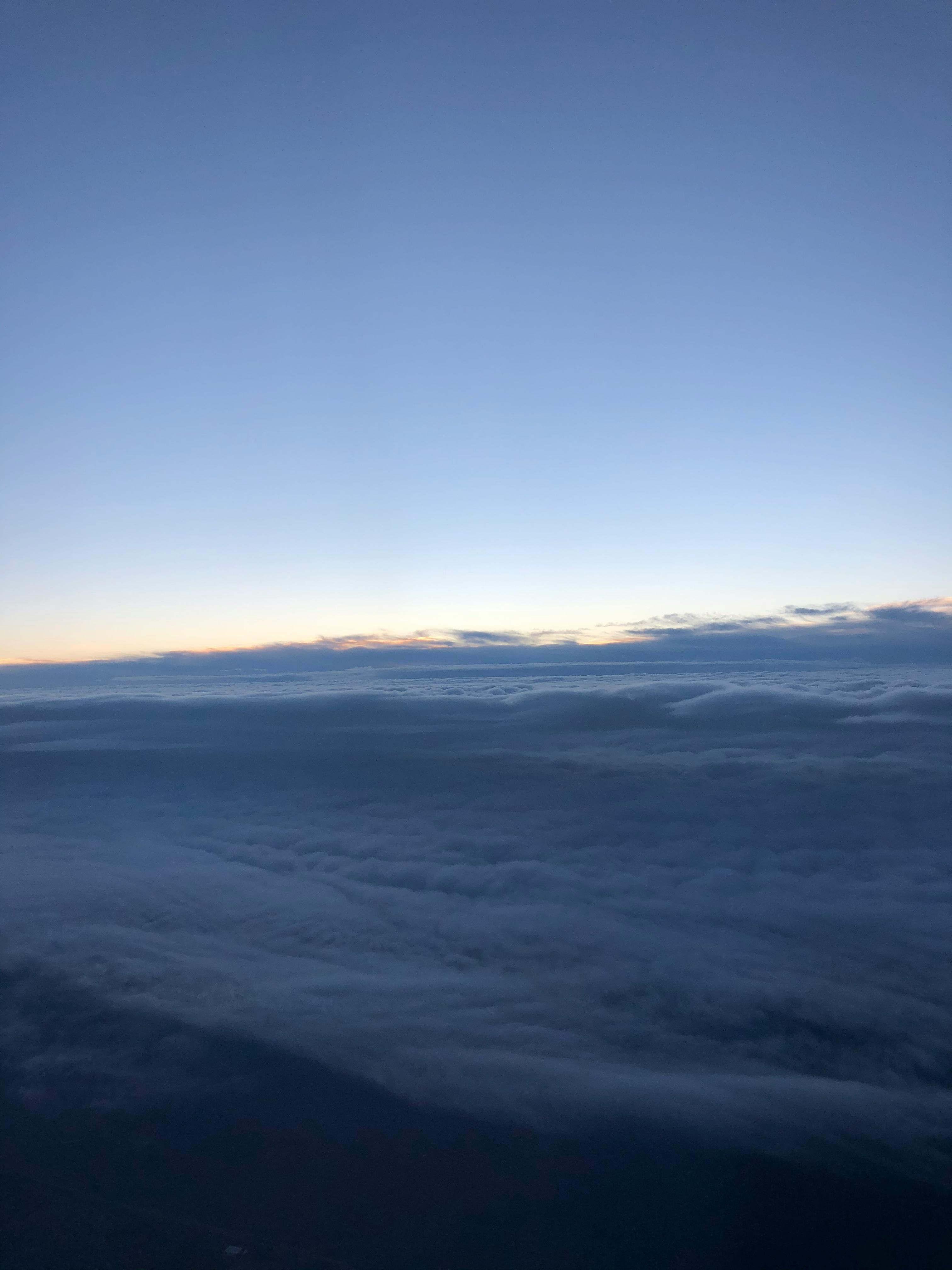 A close-up of a person's hands typing on a brightly lit mechanical gaming keyboard.