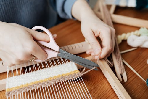 Person Cutting a Yarn