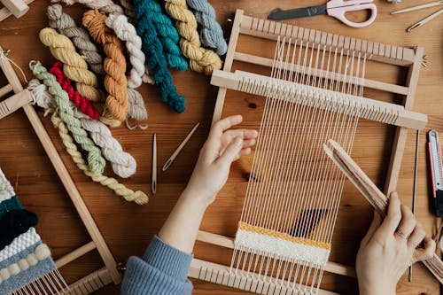 Free Top View Photo of Person Weaving Using Hand Loom Stock Photo