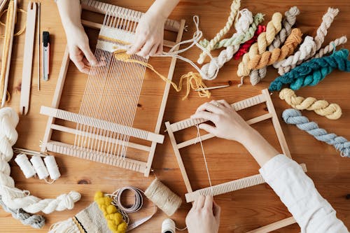 Free Top View Photo of Two Person's Hands Weaving Stock Photo