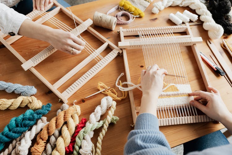 Photo Of Two Person's Hands Weaving