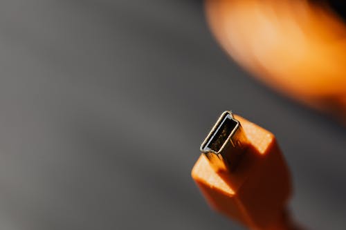 Close-Up Photo of Orange Cable Charger