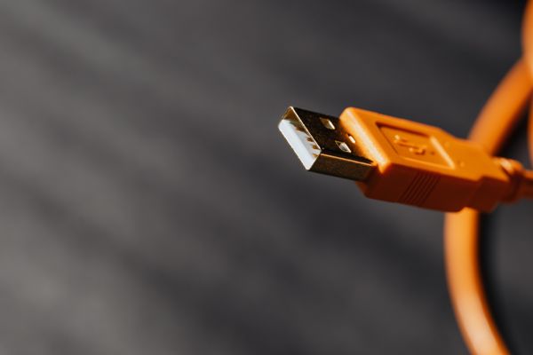 Macro photo of an orange USB cable connector — photo by kaboompics.com on Pexels