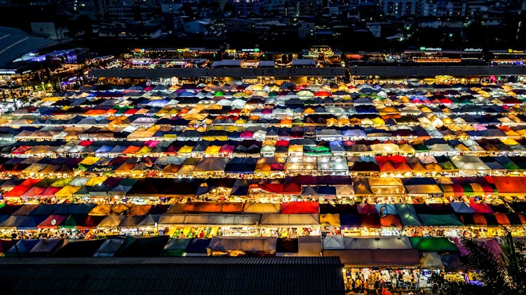 Illuminated Colorful Canopies Of Night Market Stalls