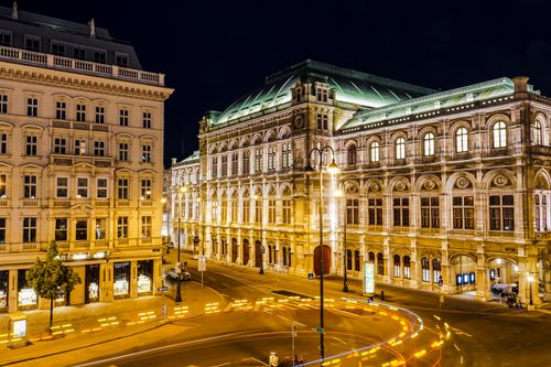 Free Illuminated Vienna State Opera at night, showcasing urban architecture and street lights. Stock Photo